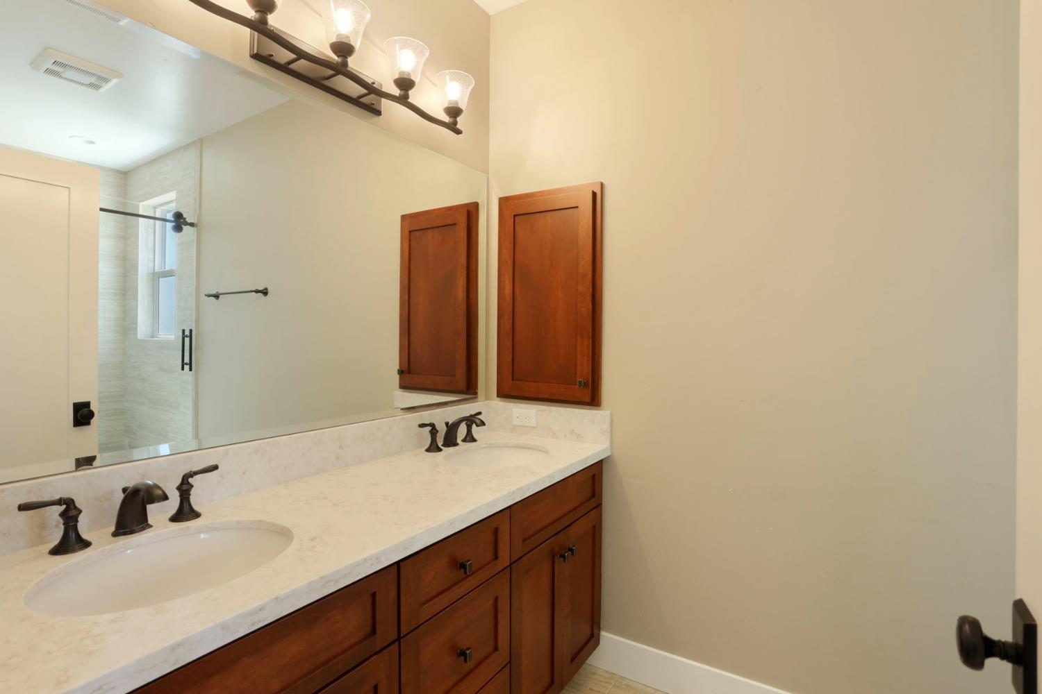 18739 Clements Road Lodi, CA 95240 - Photo 16 of 39 a bathroom with a double vanity sink and a mirror