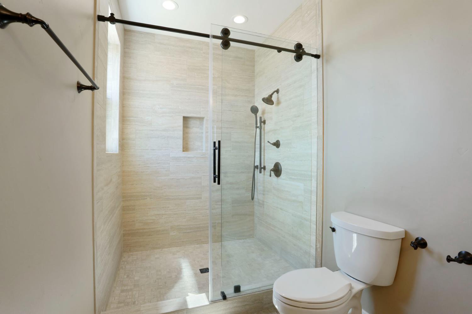 18739 Clements Road Lodi, CA 95240 - Photo 18 of 39 a bathroom with a shower and a toilet