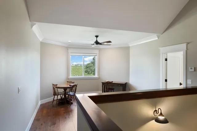 a workspace with wooden floor and a window