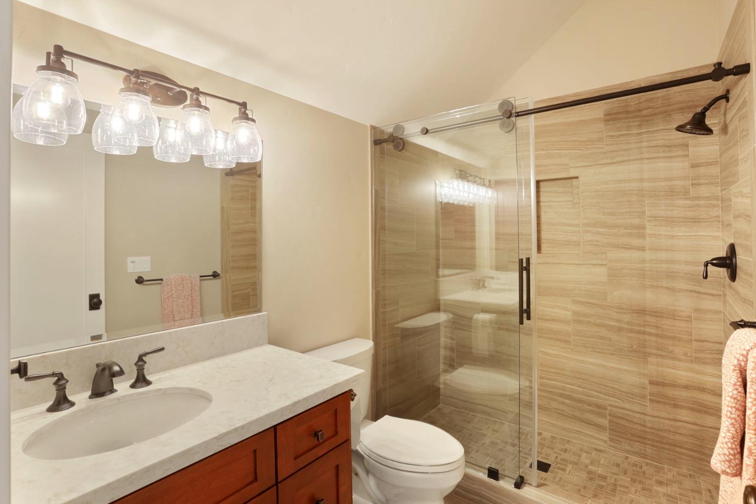 18739 Clements Road Lodi, CA 95240 - Photo 23 of 39 a bathroom with a sink mirror toilet and shower
