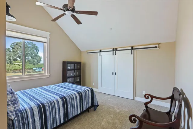 a view of a building and a floor to ceiling window next to a yard