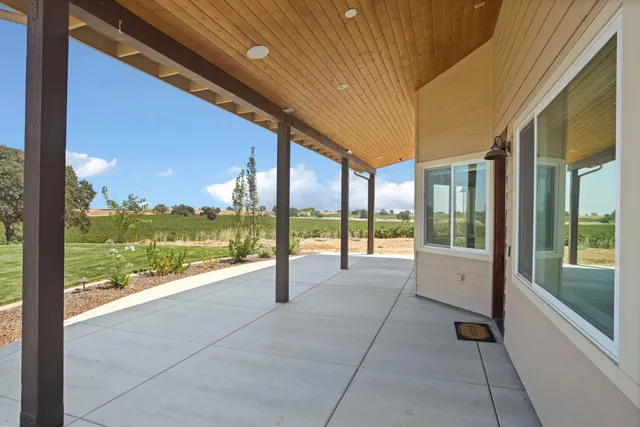 a view of a patio with a table and chairs