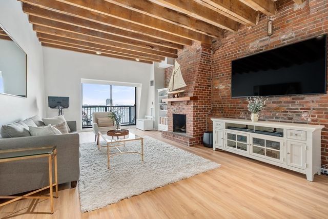 a living room with fireplace furniture and a flat screen tv
