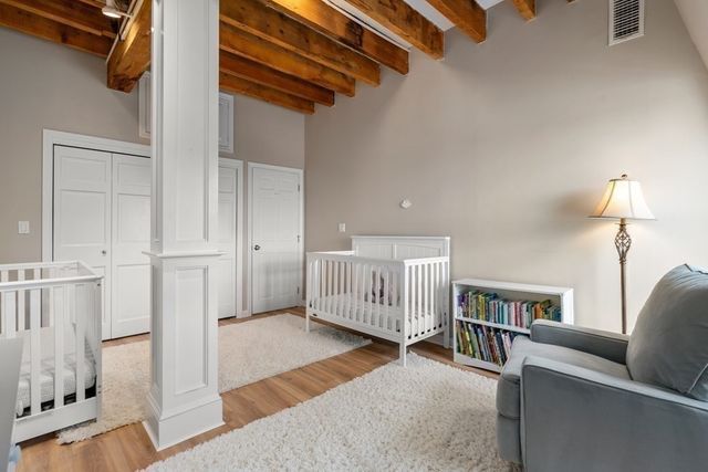 a bedroom with furniture and a rug