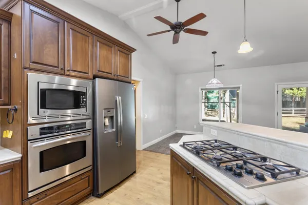a kitchen with stainless steel appliances granite countertop a stove and a refrigerator