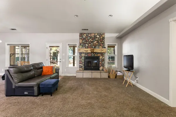 a living room with furniture a fireplace and a flat screen tv