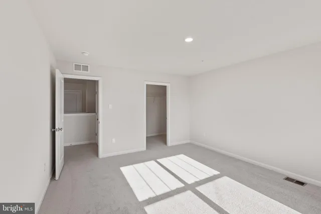 a view of an empty room and closet