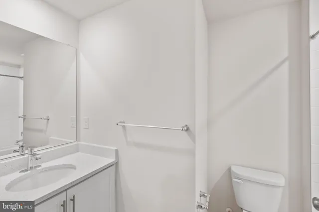 a bathroom with a sink toilet and vanity