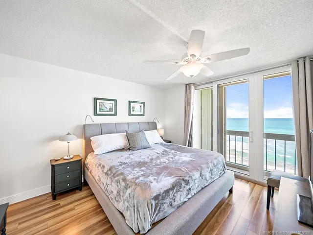 a bedroom with a large bed and a chandelier