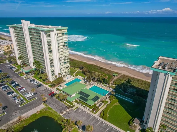a view of a tennis ground with a large pool