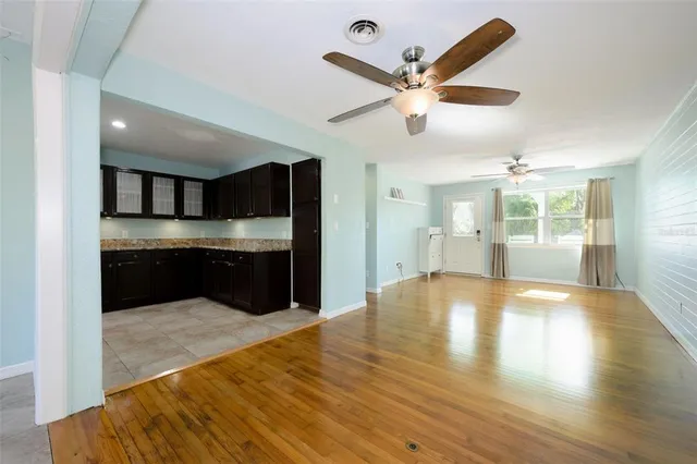 a kitchen with stainless steel appliances kitchen island granite countertop a sink stove and refrigerator
