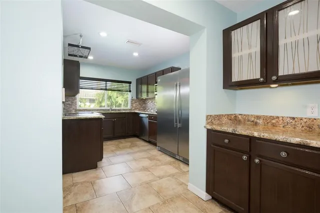 a view of empty room with fireplace and fan