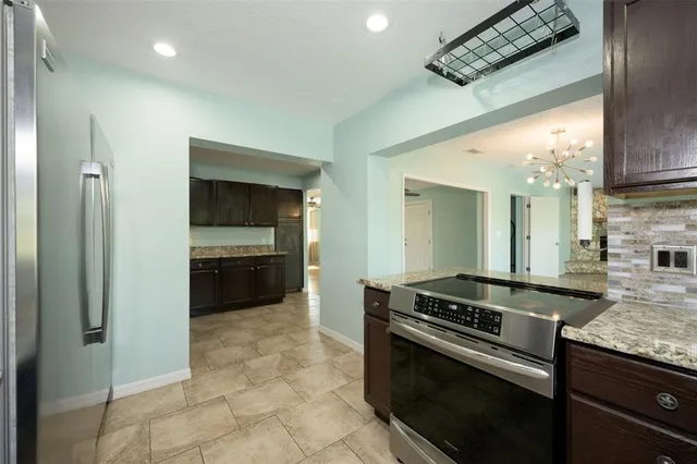 a view of room with wooden floor and ceiling fan