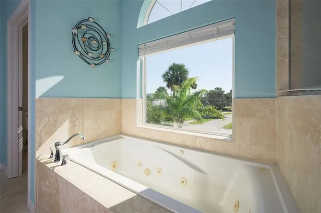 en view of an empty room with window and chandelier fan