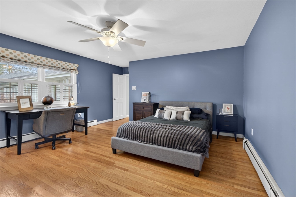 17 Karlton Circle Andover, MA 01810 - Photo 13 of 18 a bedroom with a bed a table and a potted plant