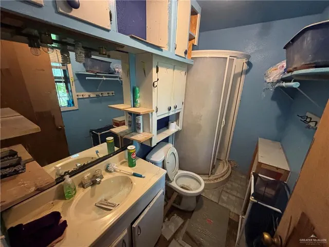 a bathroom with a sink mirror vanity and toilet