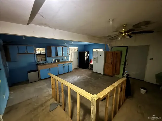 a kitchen with stainless steel appliances granite countertop a sink and a refrigerator
