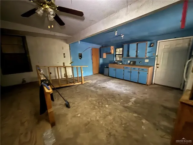 a living room with a couch and a chandelier