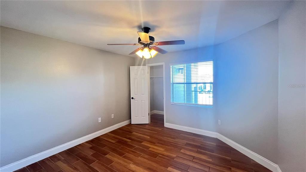 3038 Parkway Boulevard, Unit 204 Kissimmee, FL 34747 - Photo 22 of 31 a view of an empty room with window and wooden floor