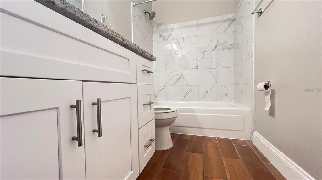 3038 Parkway Boulevard, Unit 204 Kissimmee, FL 34747 - Photo 27 of 31 a bathroom with a bathtub and a shower