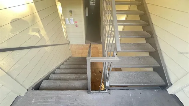 a view of staircase with white walls