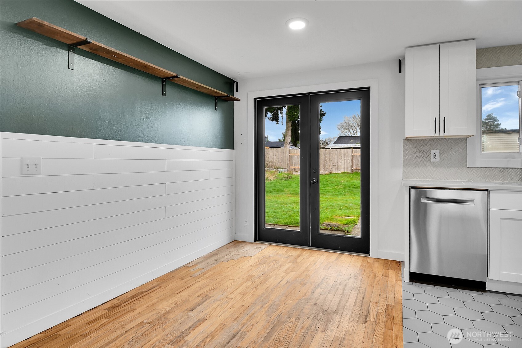 15771 119th Place Southeast Renton, WA 98058 - Photo 6 of 20 a view of an empty room with window and wooden floor