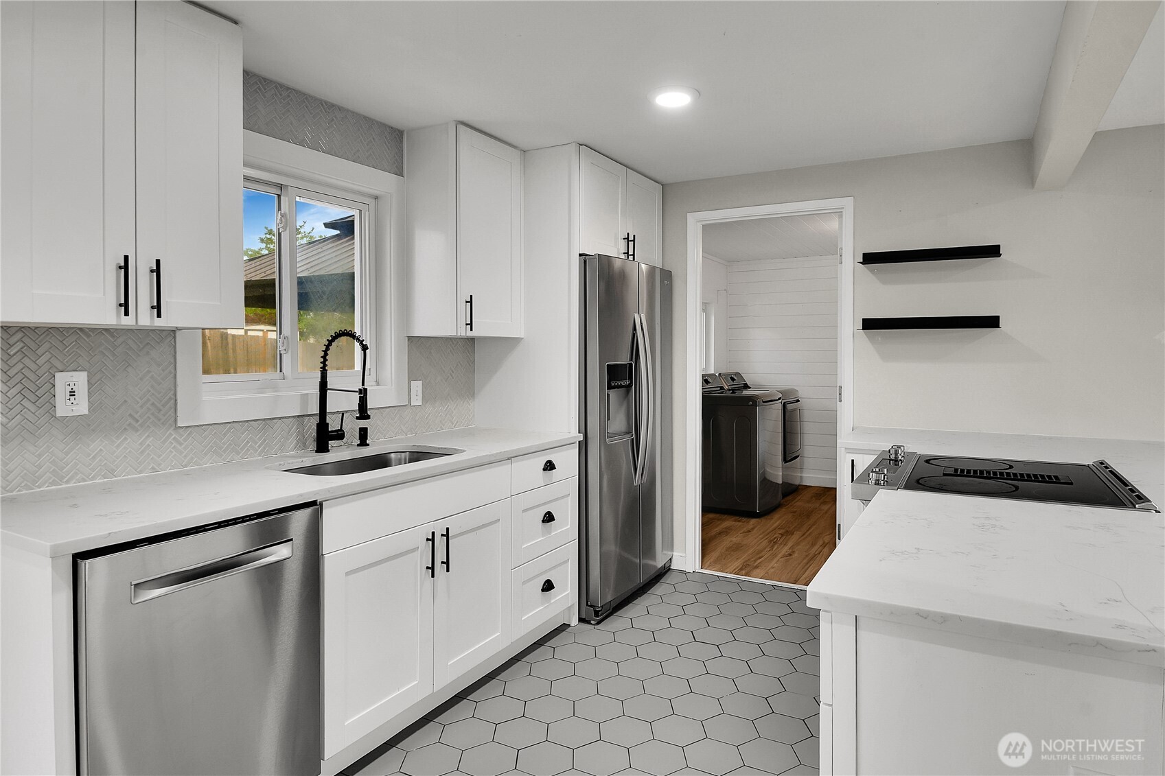 15771 119th Place Southeast Renton, WA 98058 - Photo 7 of 20 a kitchen with a sink a refrigerator and cabinets