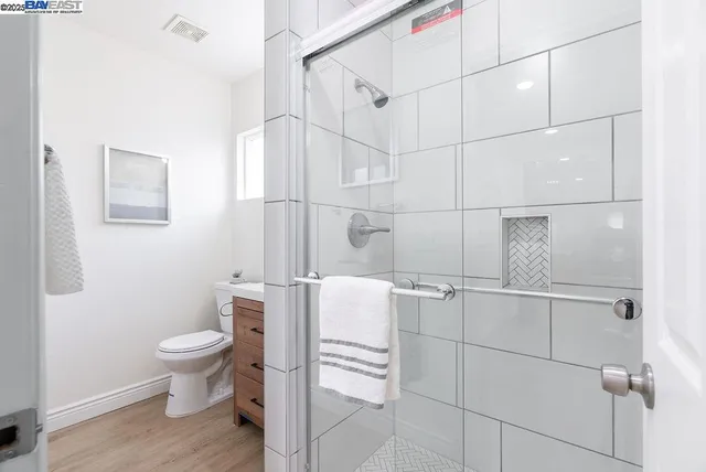 a bathroom with a sink a toilet and a mirror