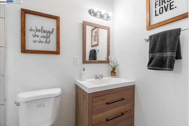 a bedroom with a bed and a night stand