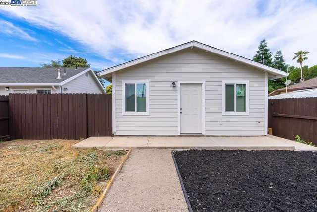 a kitchen with stainless steel appliances granite countertop a sink a stove and cabinets
