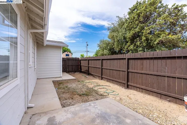 a kitchen with a sink a refrigerator and cabinets
