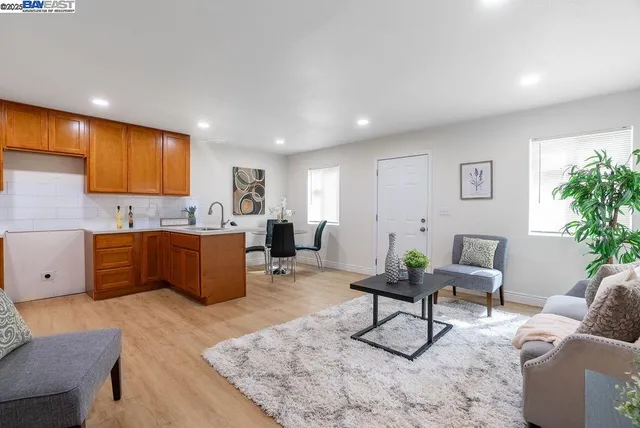 a view of a hallway with wooden floor and entryway