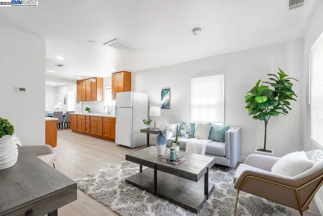 a living room with furniture and kitchen view