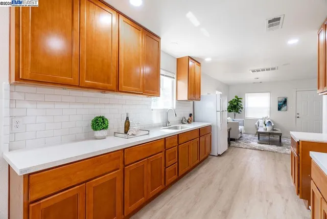 a kitchen with sink cabinets and wooden floor