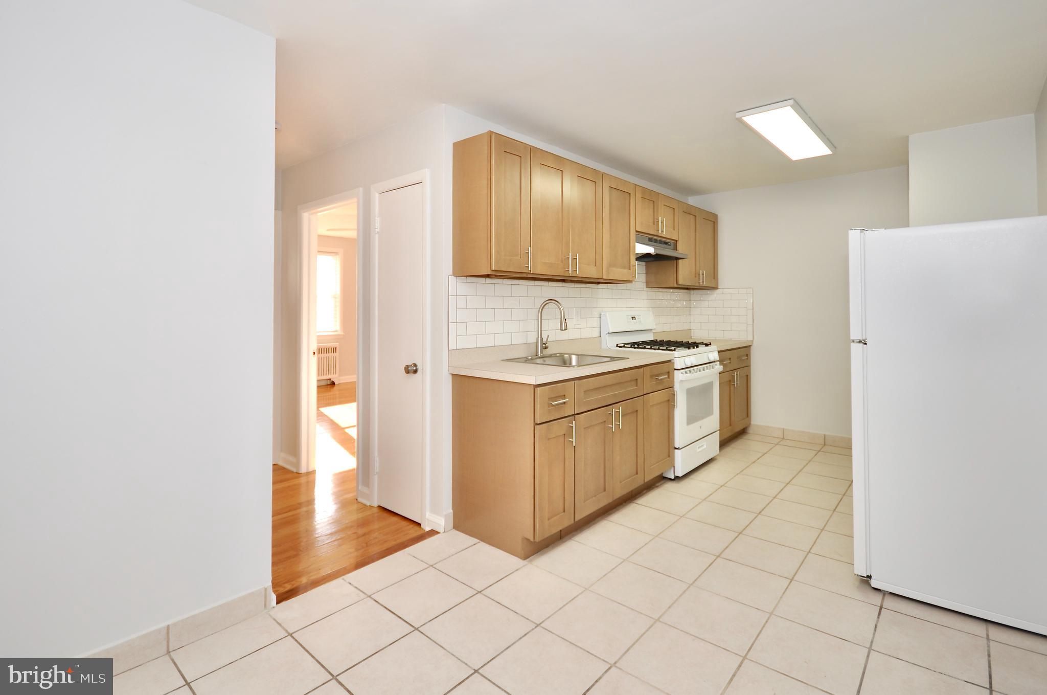 a kitchen with a sink cabinets and a window