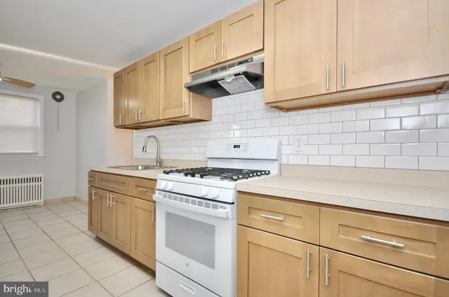 a kitchen with cabinets appliances and a sink
