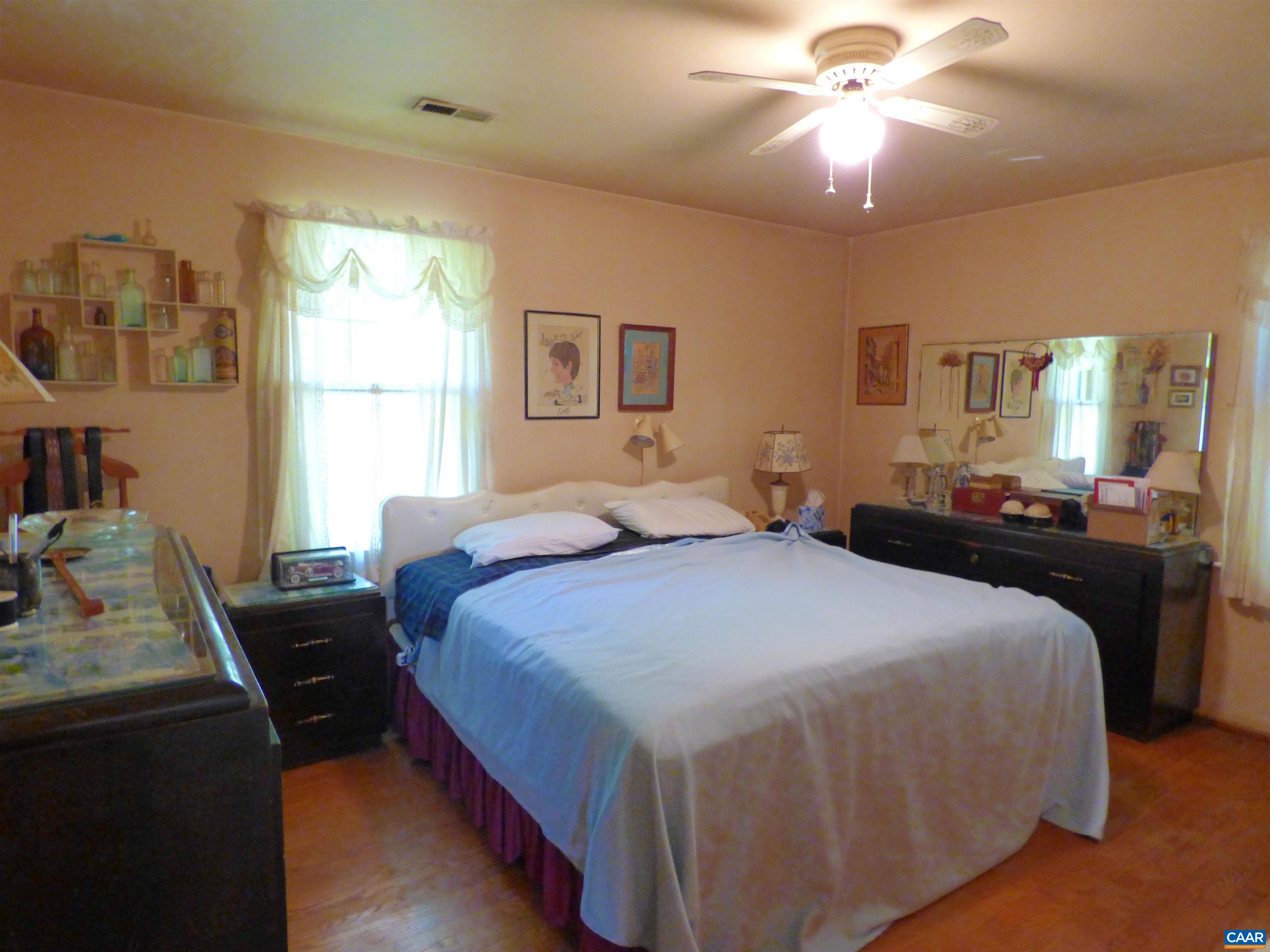 282 Kenmore Road Amherst, VA 24521 - Photo 13 of 33 a bedroom with a bed and a chandelier