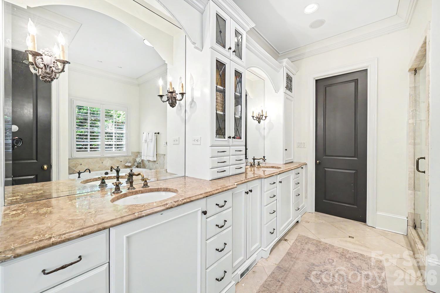 2744 Normandy Road Charlotte, NC 28209 - Photo 19 of 34 a spacious bathroom with double vanity sinks a large mirror and a shower