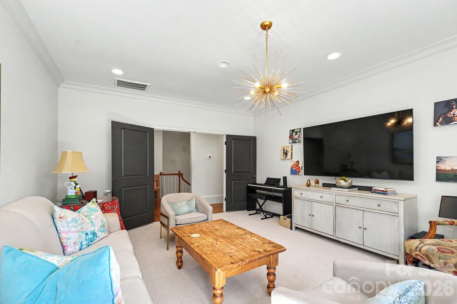 2744 Normandy Road Charlotte, NC 28209 - Photo 27 of 34 a living room with furniture and a flat screen tv