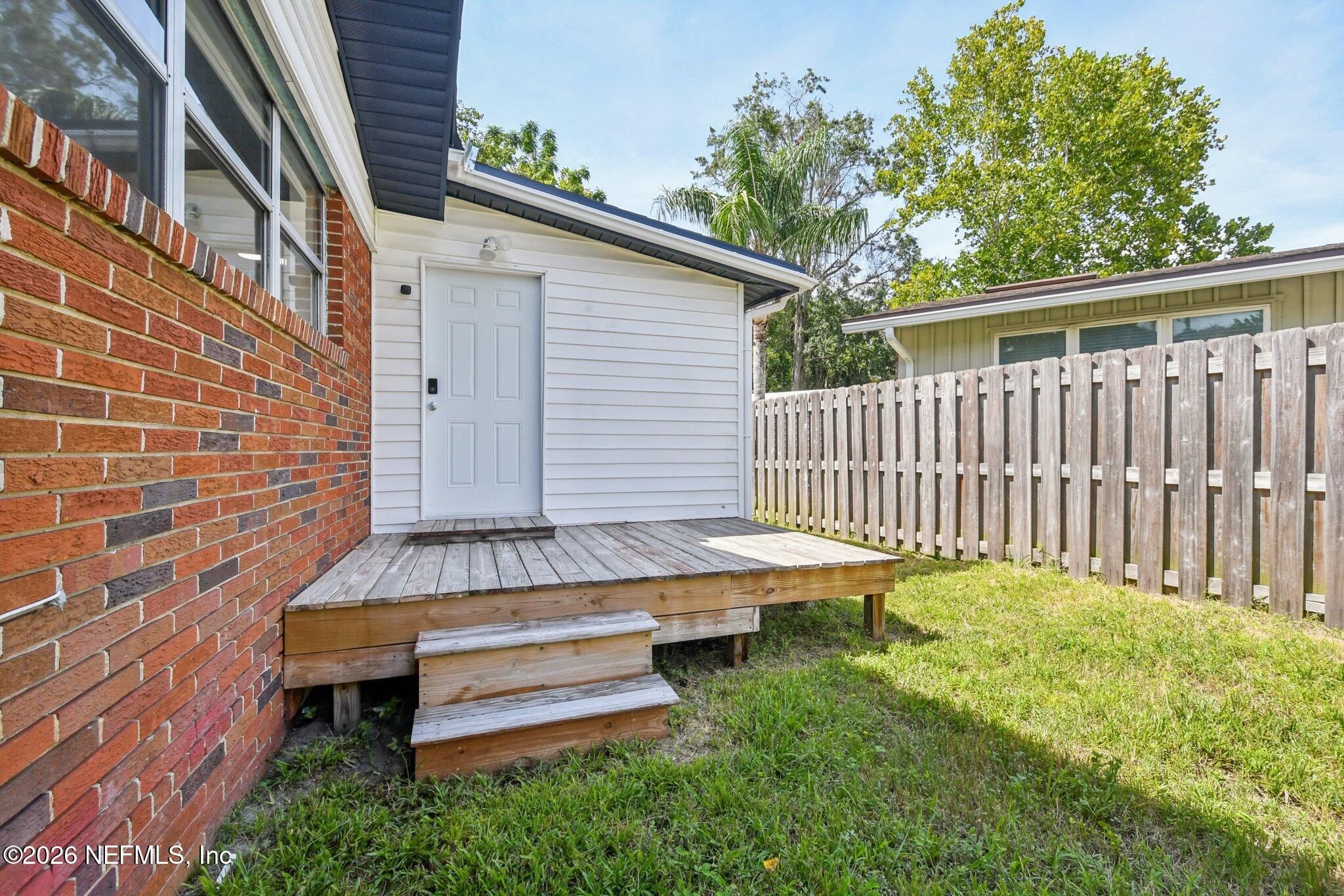 4079 Conga Street Jacksonville, FL 32217 - Photo 6 of 7 a backyard of a house with wooden floor barbeque oven and yard