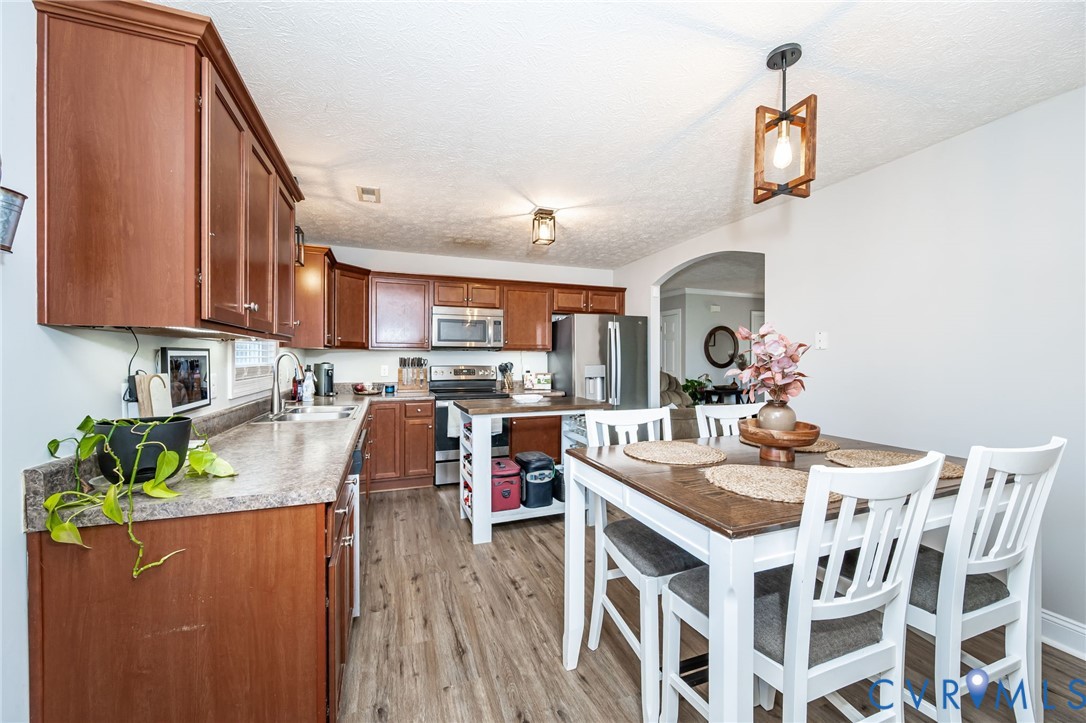 108 St Charles Place Aylett, VA 23009 - Photo 11 of 22 Kitchen featuring brown cabinetry, stainless steel