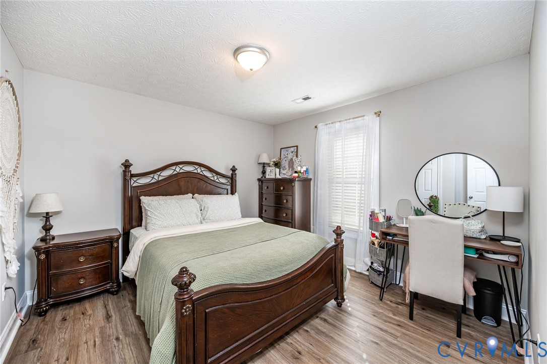 108 St Charles Place Aylett, VA 23009 - Photo 13 of 22 Bedroom with a textured ceiling and wood finished