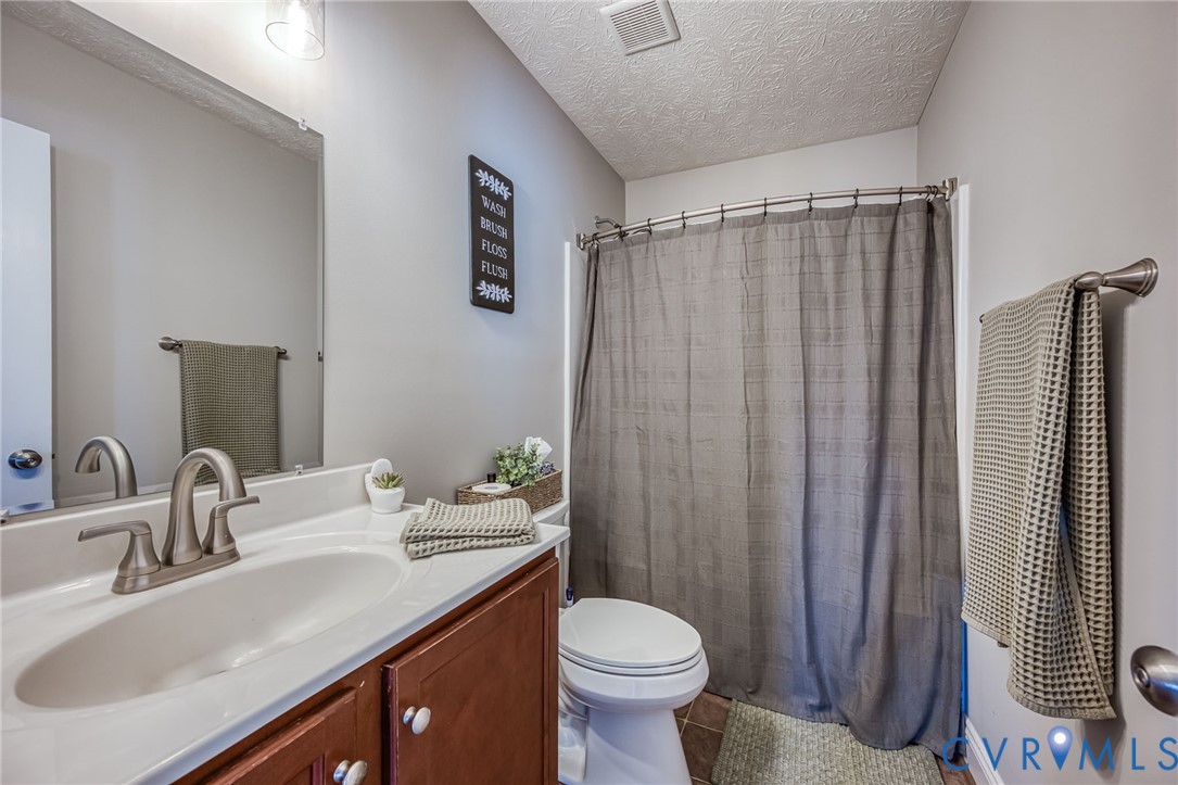 108 St Charles Place Aylett, VA 23009 - Photo 14 of 22 Bathroom featuring vanity, a shower with curtain,