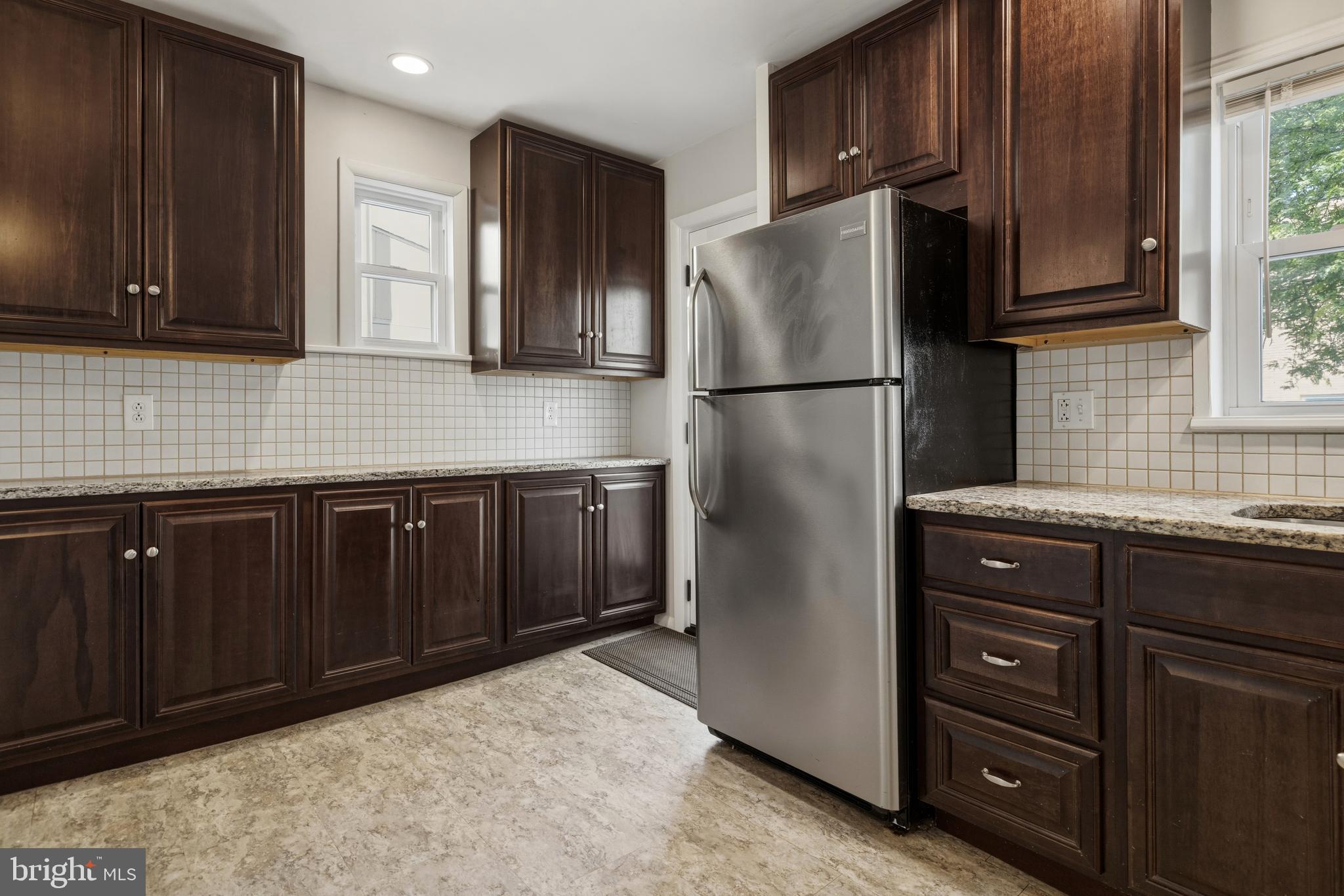 229 Wayne Avenue Narberth, PA 19072 - Photo 14 of 35 a kitchen with stainless steel appliances granite countertop a refrigerator a stove a sink and a cabinets