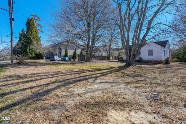 a view of a yard with a house and trees