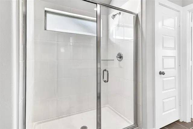 a bathroom with a glass shower door