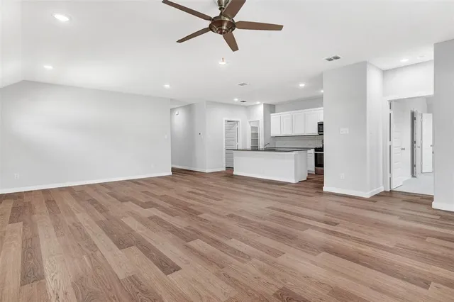 a view of a kitchen with a sink and a refrigerator