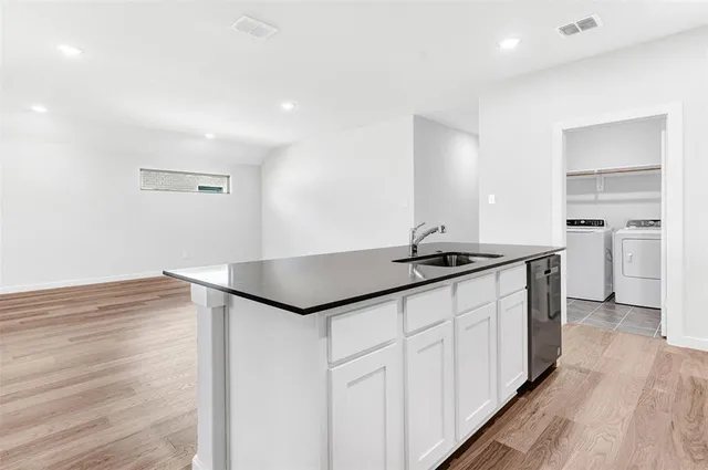 a kitchen with granite countertop a sink and a stove top oven