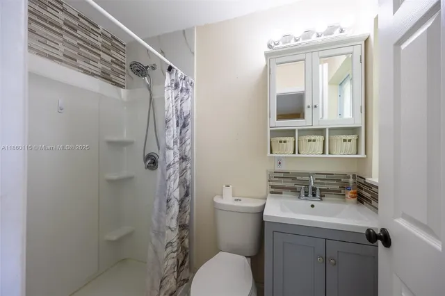 a livingroom with workspace a couch and a window