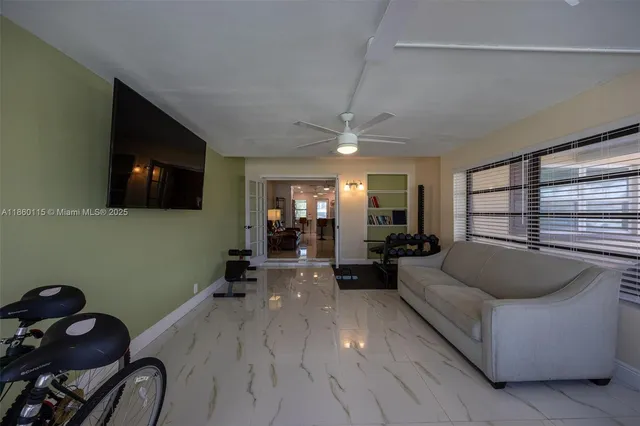 a living room with furniture kitchen view and a chandelier